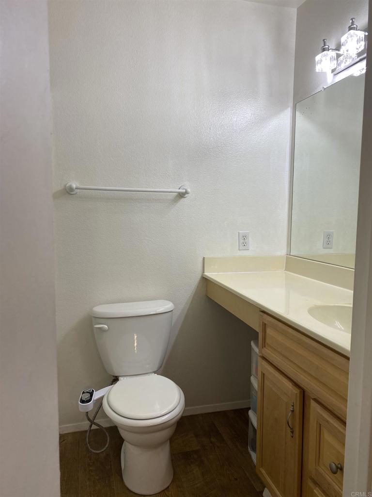 230 Diamond Way, Unit 148 Vista, CA 92083 - Photo 8 of 18 a bathroom with a sink toilet and a mirror