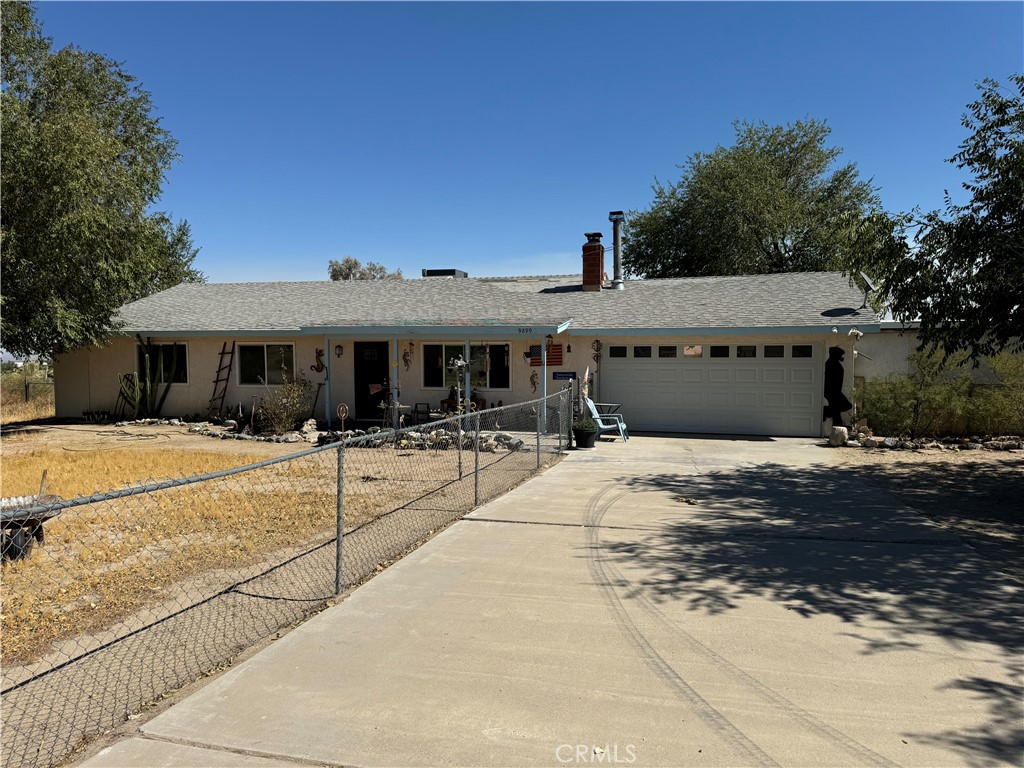 9899 Riggins Road Phelan, CA 92371 - Photo 1 of 1 a front view of a house with a yard