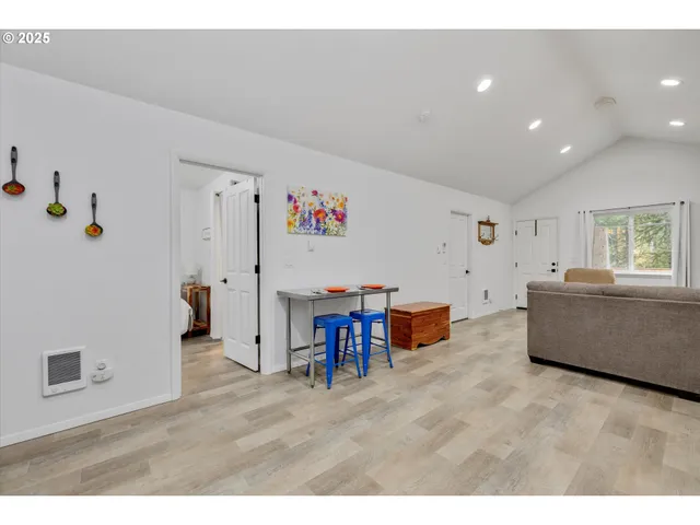 a living room with furniture and a dining table