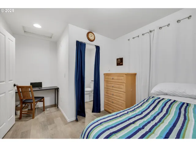 a bedroom with a bed and a chair