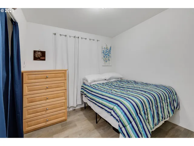 a bedroom with a bed and a cabinet