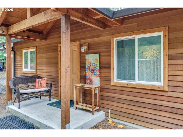 a view of a house with a chairs and table in a patio