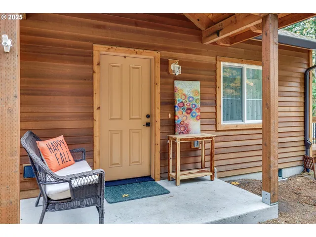 a backyard of a house with barbeque oven table and chairs