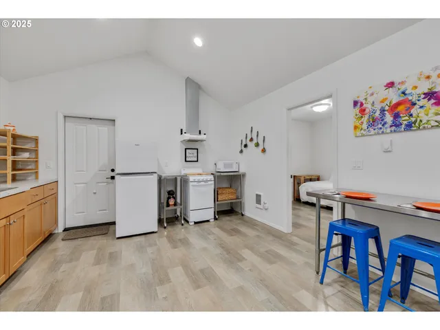 a view of a workspace with furniture and wooden floor