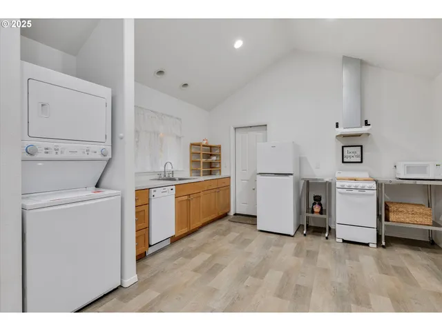 a kitchen with cabinets and wooden floors