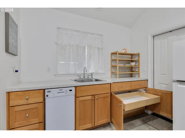 a kitchen with a sink cabinets and wooden floor