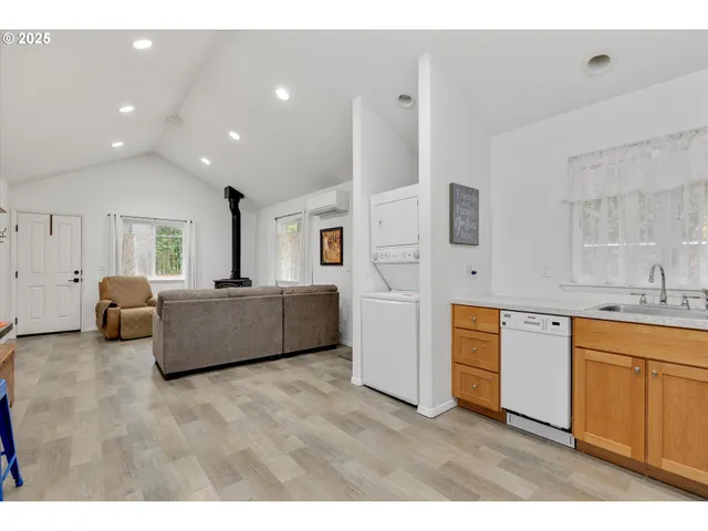a living room with furniture and kitchen view
