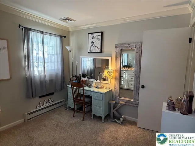 a view of a workspace with furniture and a window