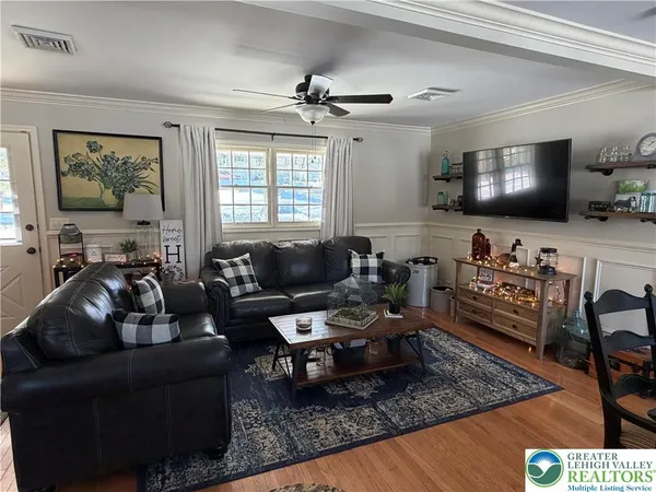 a living room with furniture and a flat screen tv