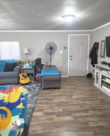 a living room with furniture and a wooden floor