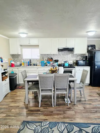 a kitchen with a table chairs stove and cabinets