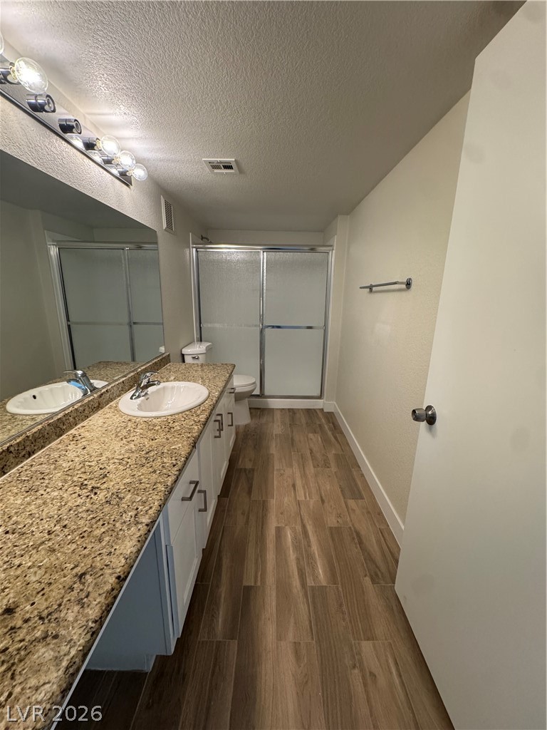 8101 West Flamingo Road, Unit 1040 Las Vegas, NV 89147 - Photo 15 of 22 This bathroom features a double vanity and sleek shower enclosure for a contemporary feel.