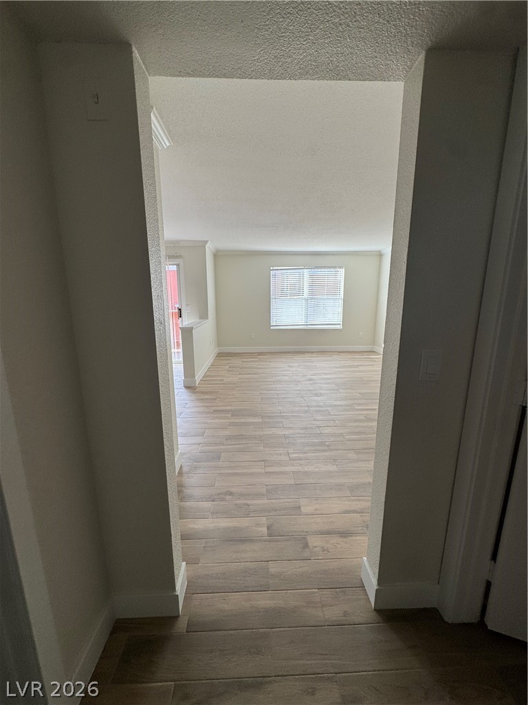 8101 West Flamingo Road, Unit 1040 Las Vegas, NV 89147 - Photo 17 of 22 This interior hallway features sleek flooring and bright natural light.