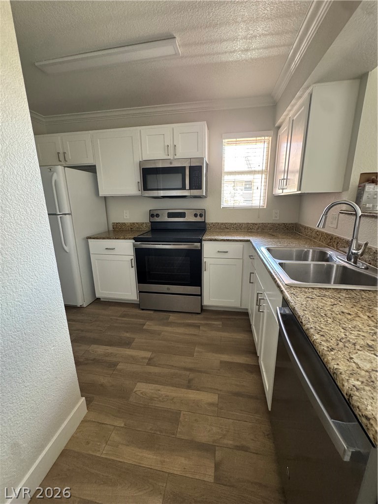 8101 West Flamingo Road, Unit 1040 Las Vegas, NV 89147 - Photo 20 of 22 This modern kitchen features warm wood-look flooring and efficient stainless steel appliances.