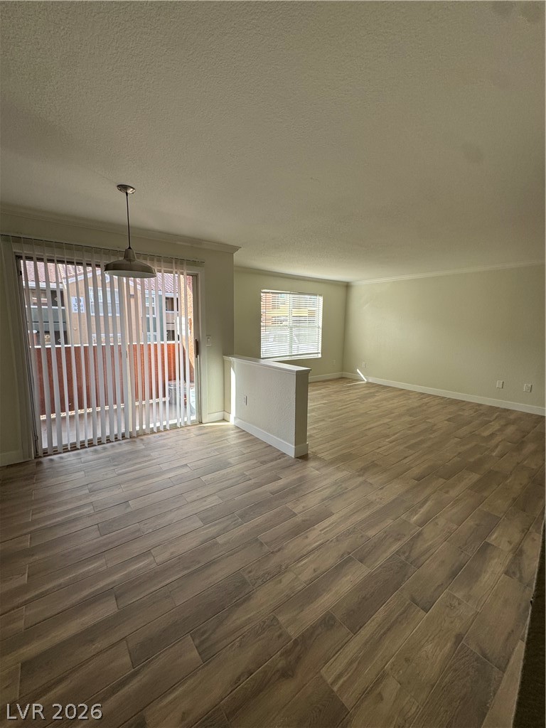 8101 West Flamingo Road, Unit 1040 Las Vegas, NV 89147 - Photo 5 of 22 This living space features warm wood flooring and ample natural light through multiple windows.