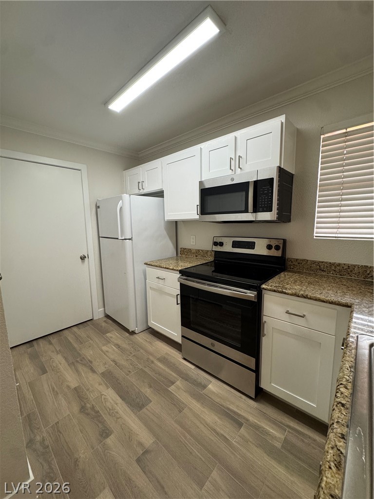 8101 West Flamingo Road, Unit 1040 Las Vegas, NV 89147 - Photo 7 of 22 This modern kitchen features contemporary white cabinetry and durable countertops, perfect for daily living.