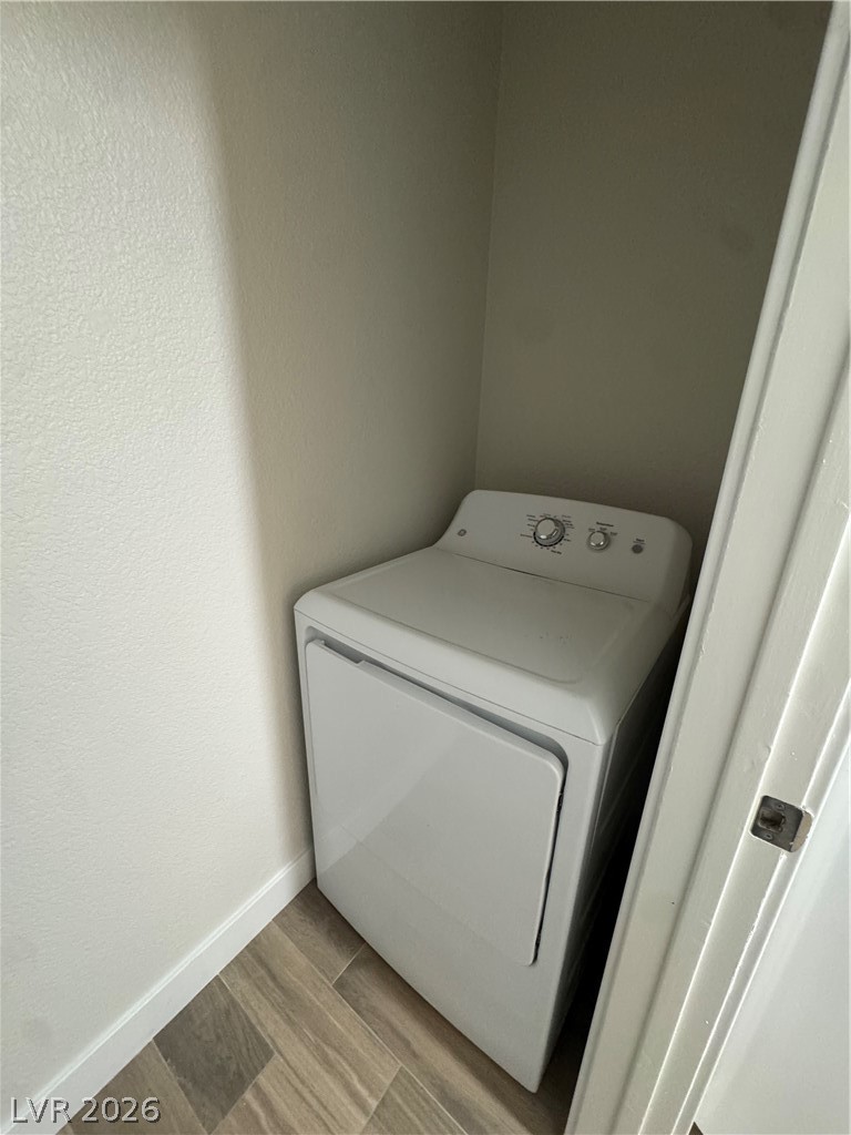 8101 West Flamingo Road, Unit 1040 Las Vegas, NV 89147 - Photo 9 of 22 This compact laundry area features a dryer, optimizing space and utility for daily chores.