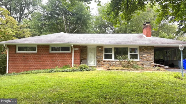a front view of a house with yard and outdoor seating