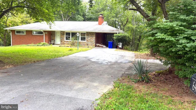a view of a house with a yard and sitting area