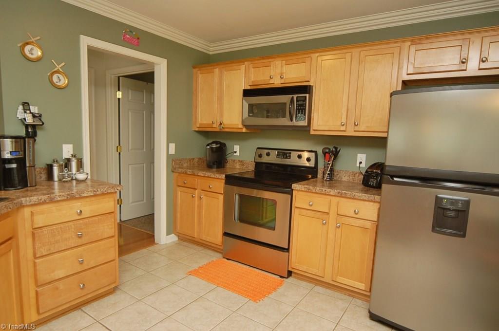 3809 Payne Road High Point, NC 27265 - Photo 10 of 30 Kitchen has tiled floor and stainless appliances.