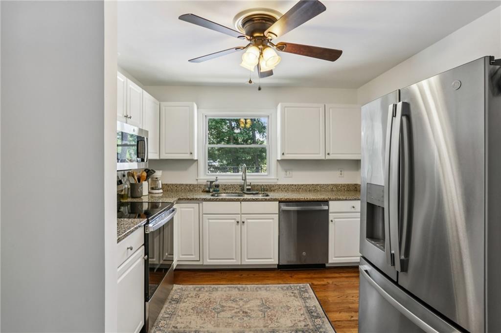 2740 Frontier Trail Atlanta, GA 30341 - Photo 15 of 29 a kitchen with stainless steel appliances granite countertop a refrigerator a sink dishwasher a stove top oven a sink and dishwasher
