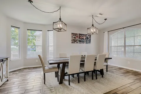a view of a dining room with furniture window and wooden floor