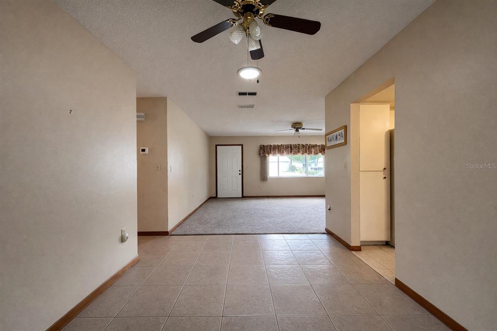 11268 Southwest 75th Terrace Ocala, FL 34476 - Photo 19 of 32 en empty room with windows and ceiling fan