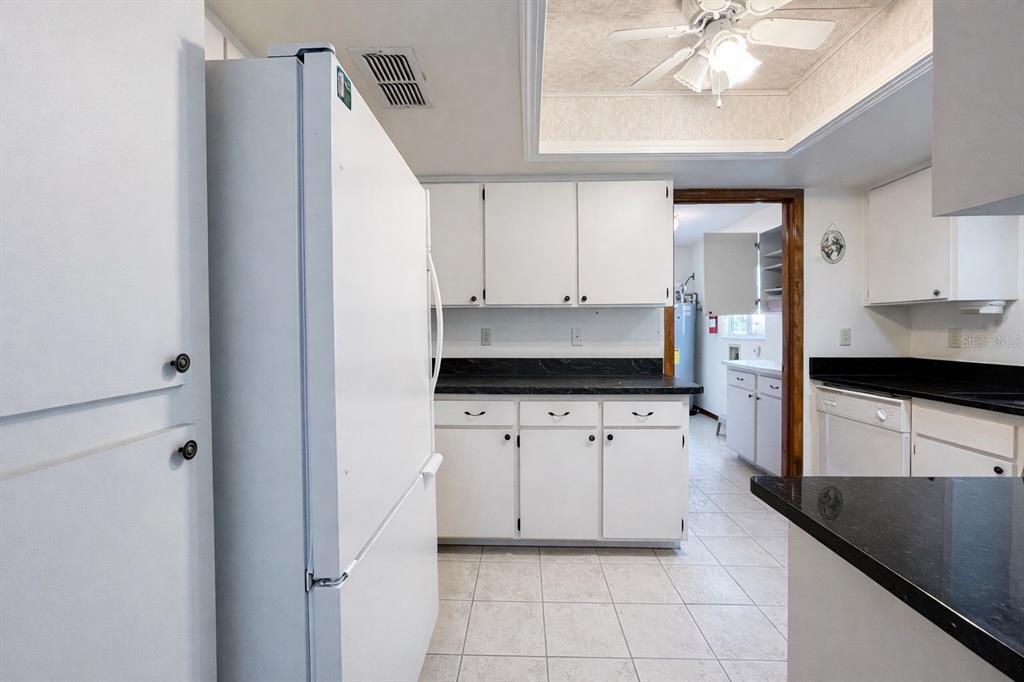 11268 Southwest 75th Terrace Ocala, FL 34476 - Photo 20 of 32 a kitchen with a refrigerator and a stove top oven