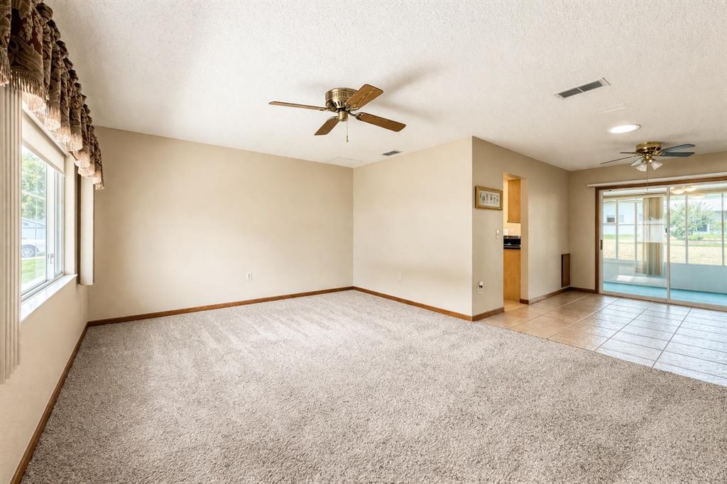 11268 Southwest 75th Terrace Ocala, FL 34476 - Photo 4 of 32 wooden floor in an empty room with a window