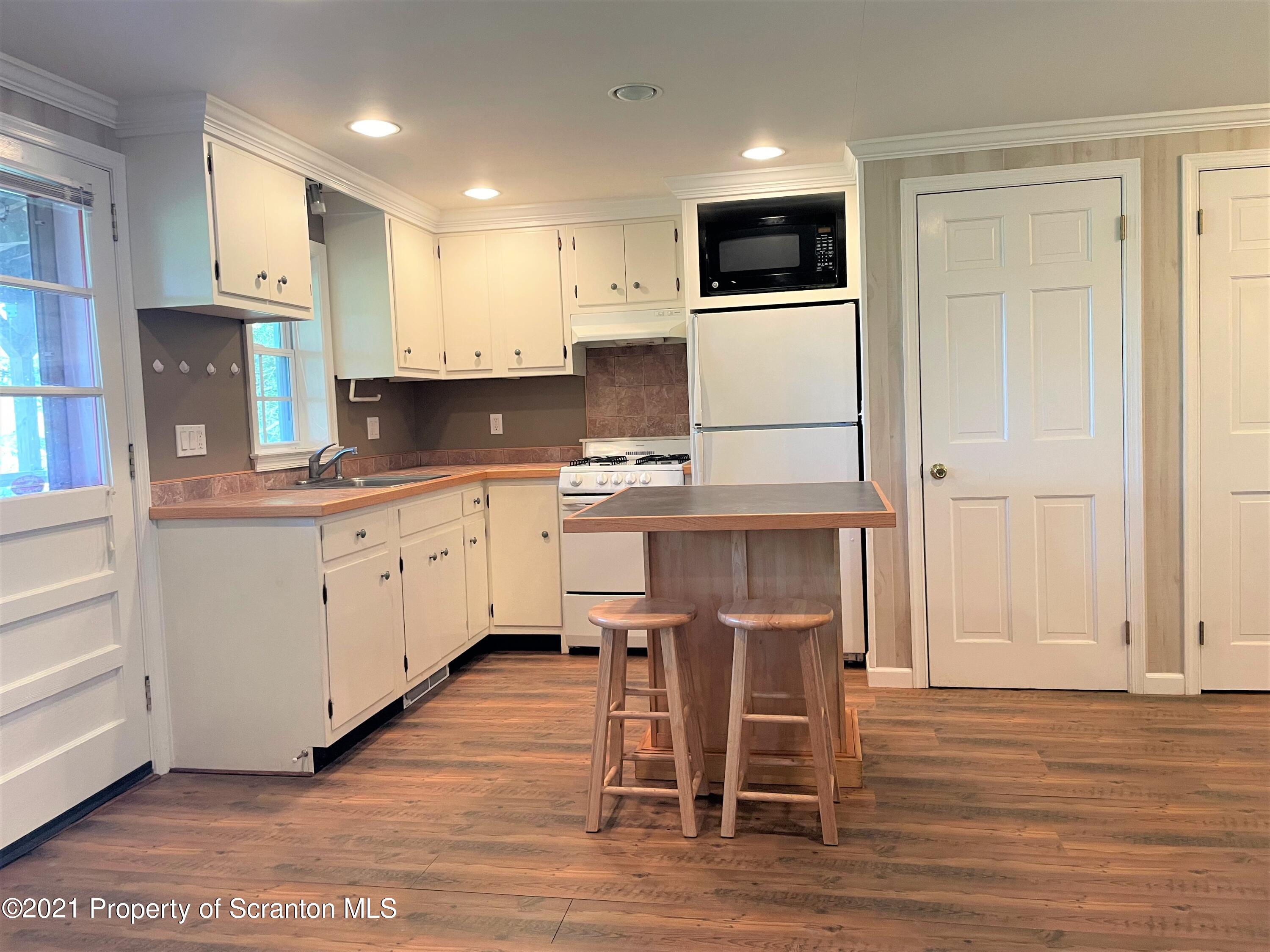 705-771 Hunter Road Springville, PA 18844 - Photo 25 of 62 a kitchen with a sink cabinets and wooden floor