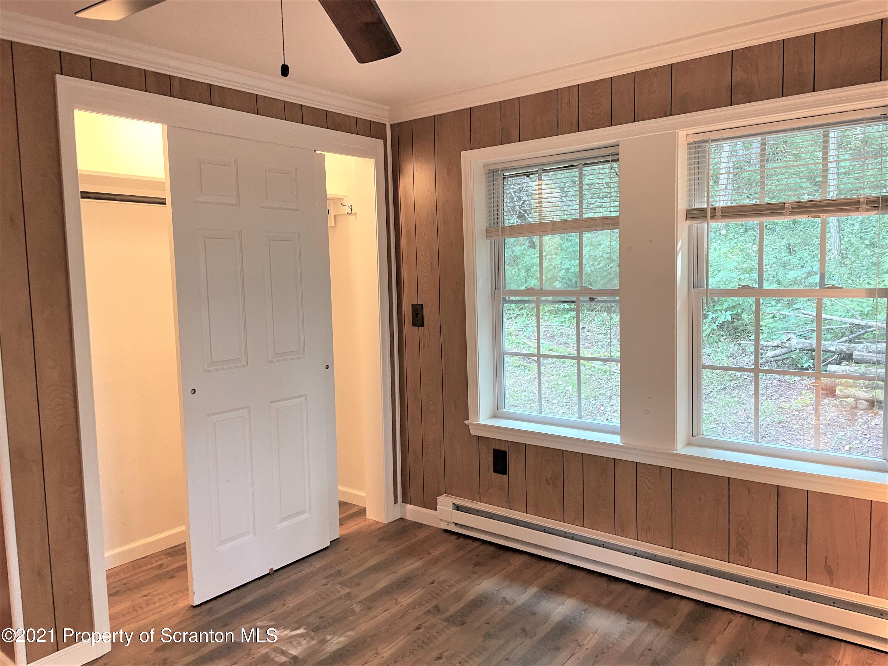 705-771 Hunter Road Springville, PA 18844 - Photo 31 of 62 an empty room with wooden floor and windows