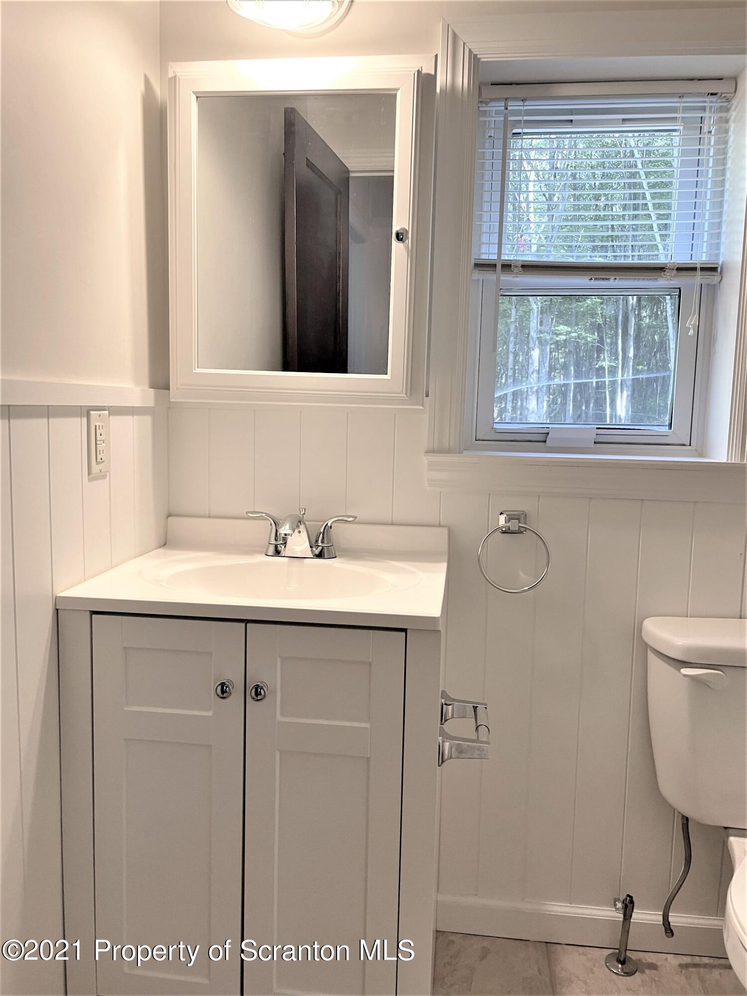 705-771 Hunter Road Springville, PA 18844 - Photo 37 of 62 a bathroom with a sink a toilet and a mirror