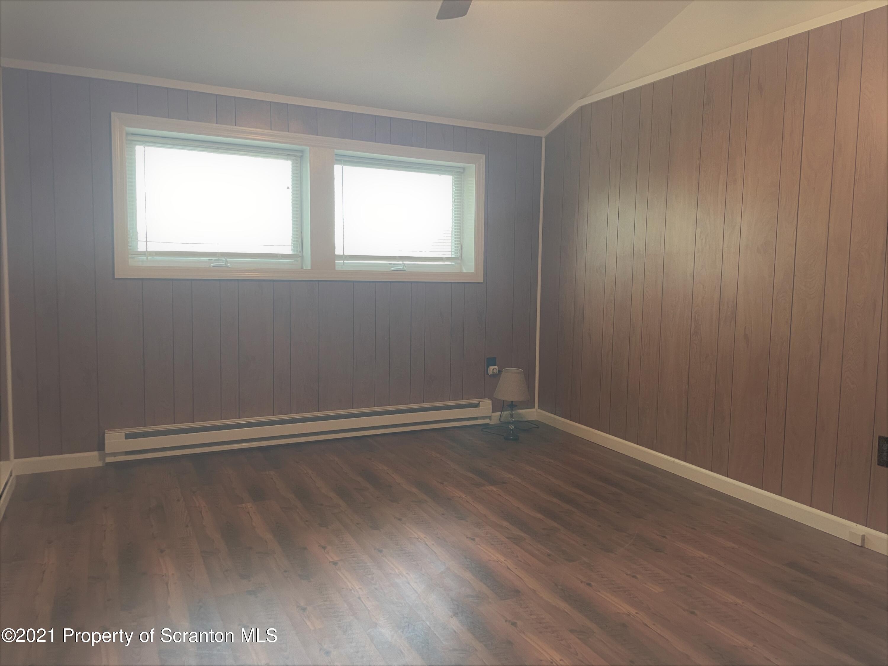 705-771 Hunter Road Springville, PA 18844 - Photo 38 of 62 a view of an empty room with wooden floor and a window