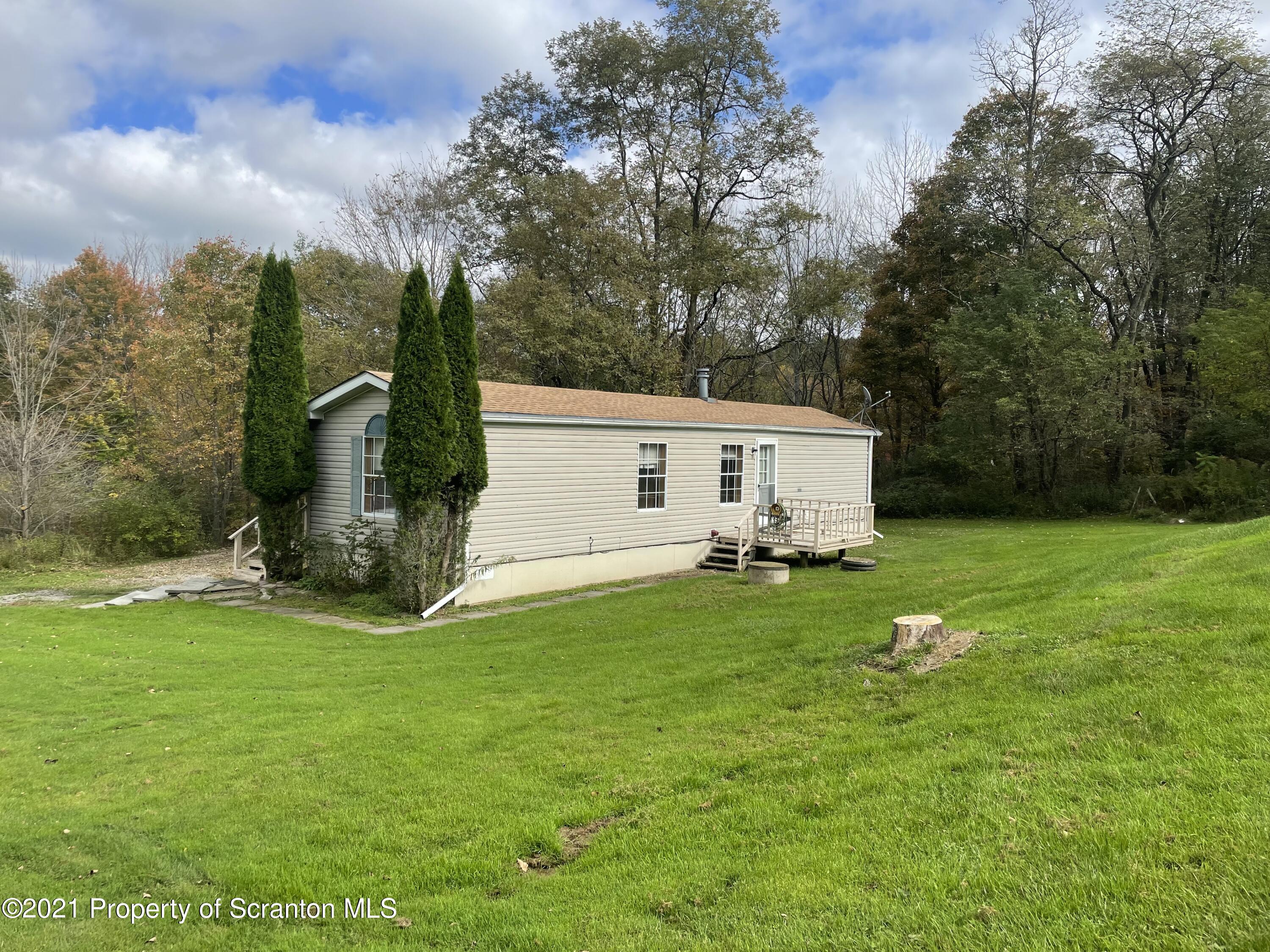 705-771 Hunter Road Springville, PA 18844 - Photo 45 of 62 a front view of house with yard and green space
