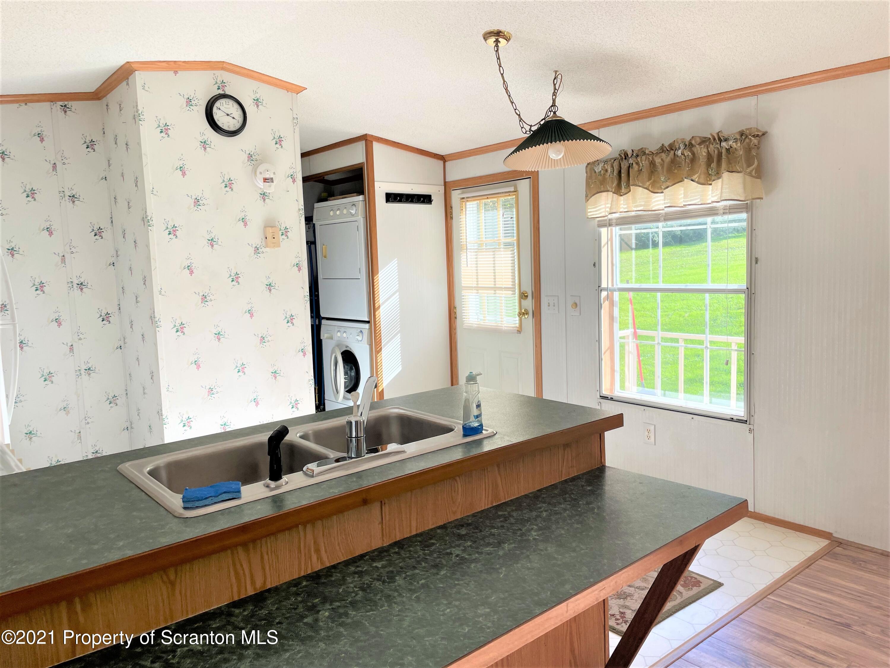 705-771 Hunter Road Springville, PA 18844 - Photo 51 of 62 a bathroom with a granite countertop sink and a large mirror