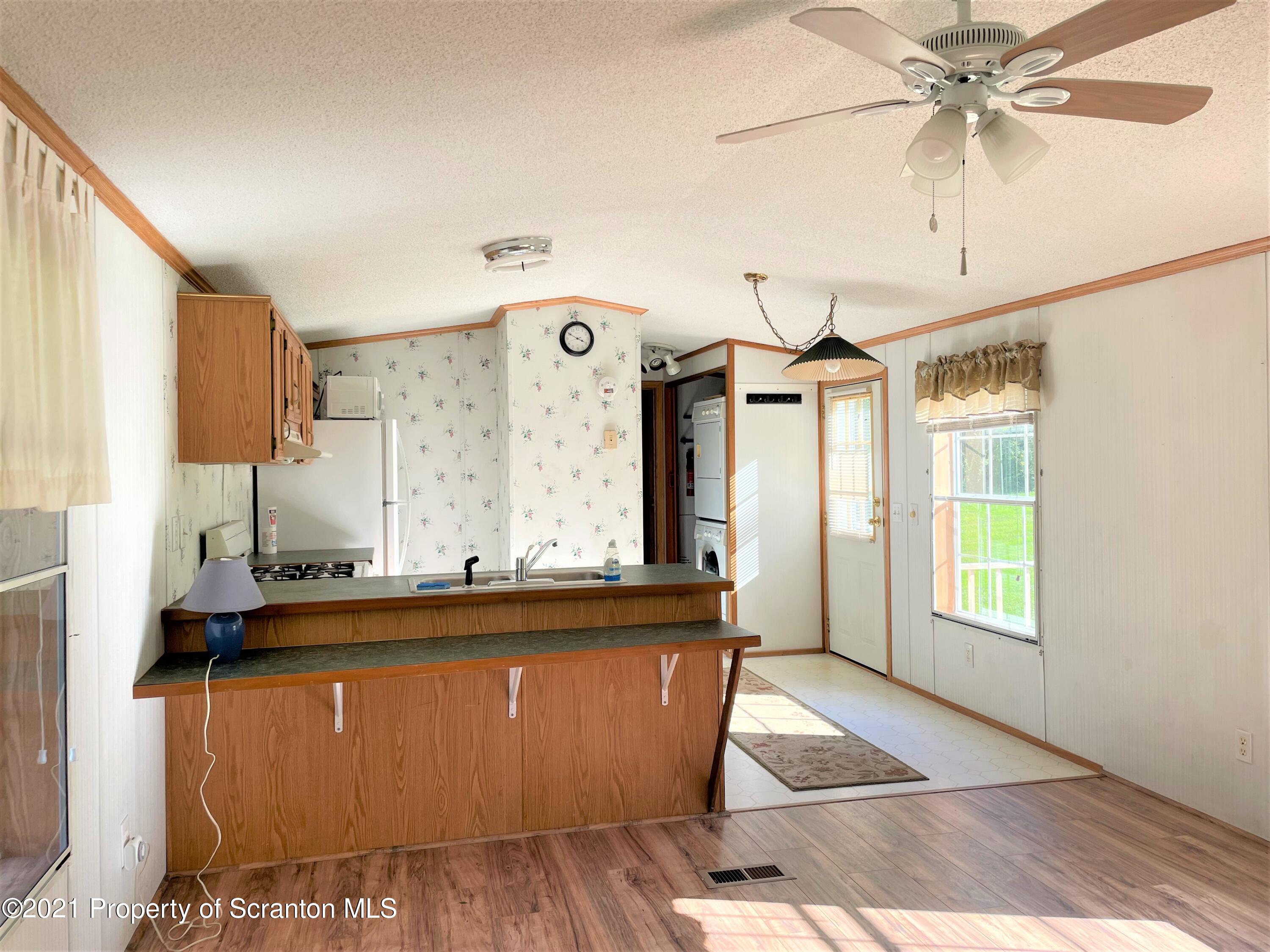 705-771 Hunter Road Springville, PA 18844 - Photo 52 of 62 a view of a kitchen with a sink cabinets and window