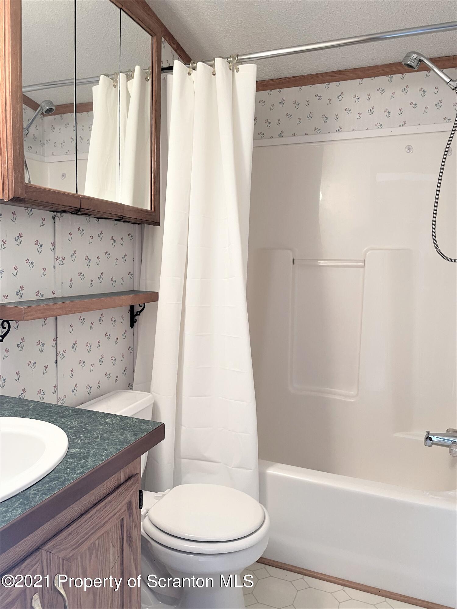 705-771 Hunter Road Springville, PA 18844 - Photo 58 of 62 a bathroom with a granite countertop sink toilet and shower
