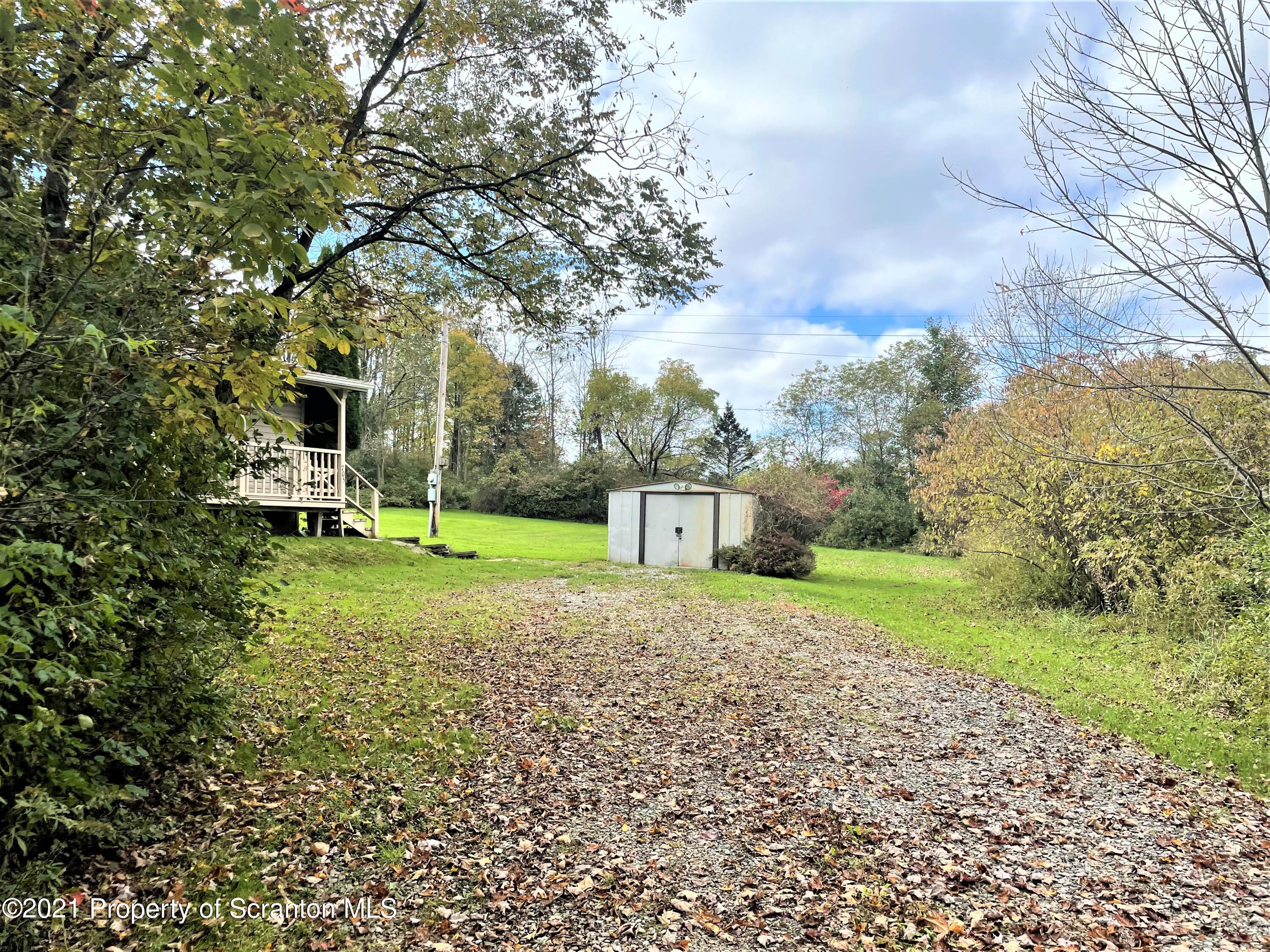 705-771 Hunter Road Springville, PA 18844 - Photo 61 of 62 a front view of a house with a yard and trees