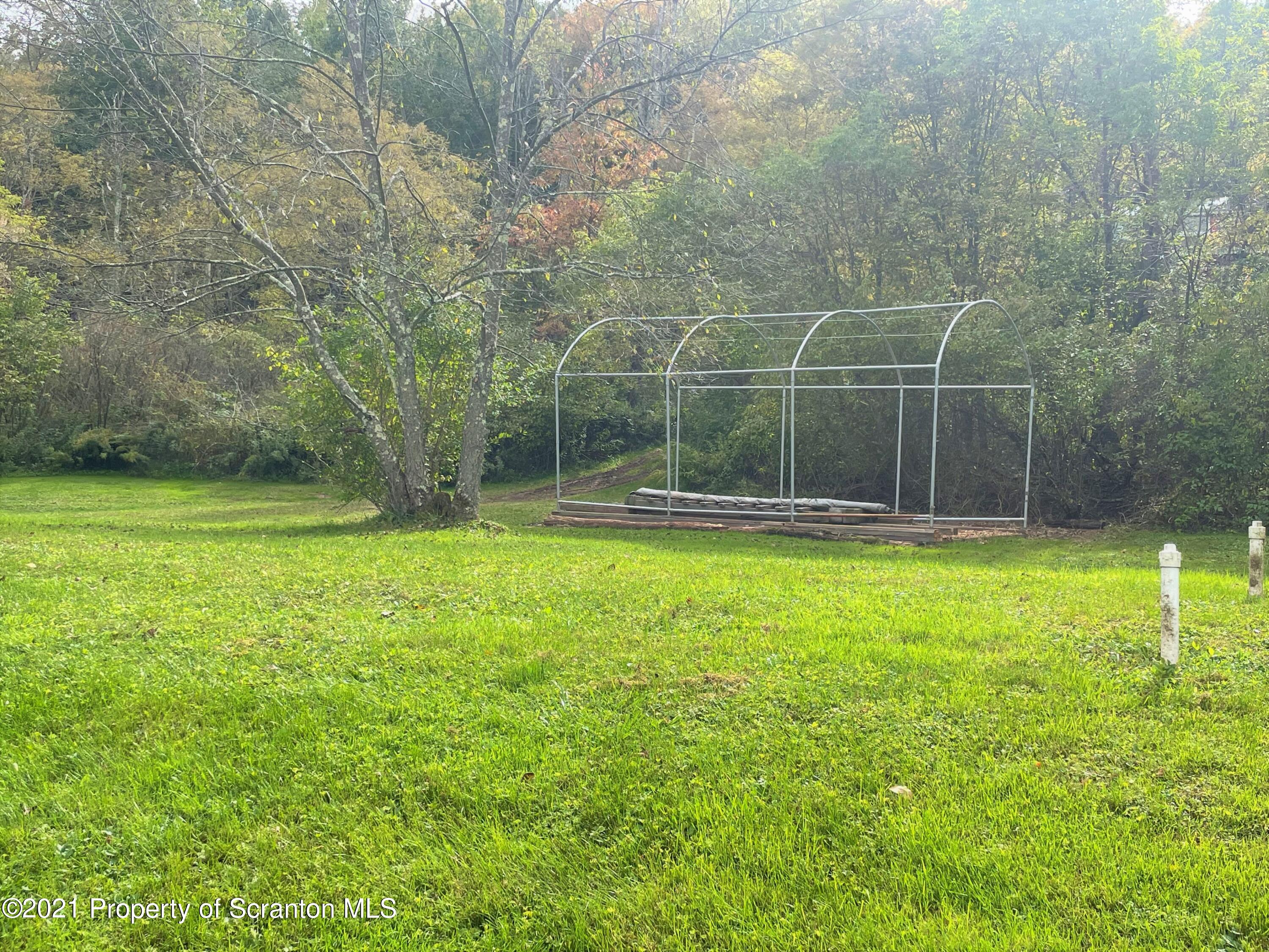 705-771 Hunter Road Springville, PA 18844 - Photo 62 of 62 a view of a backyard with a trees