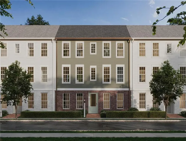 a front view of a residential apartment building with a yard