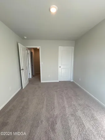 a view of an empty room and closet area