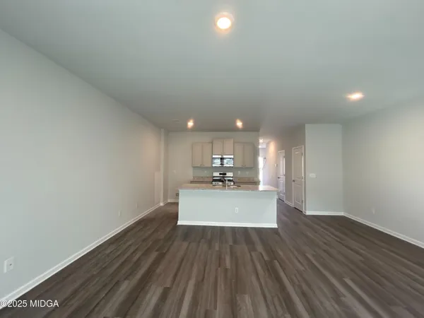 a view of a kitchen with a sink and wooden floor