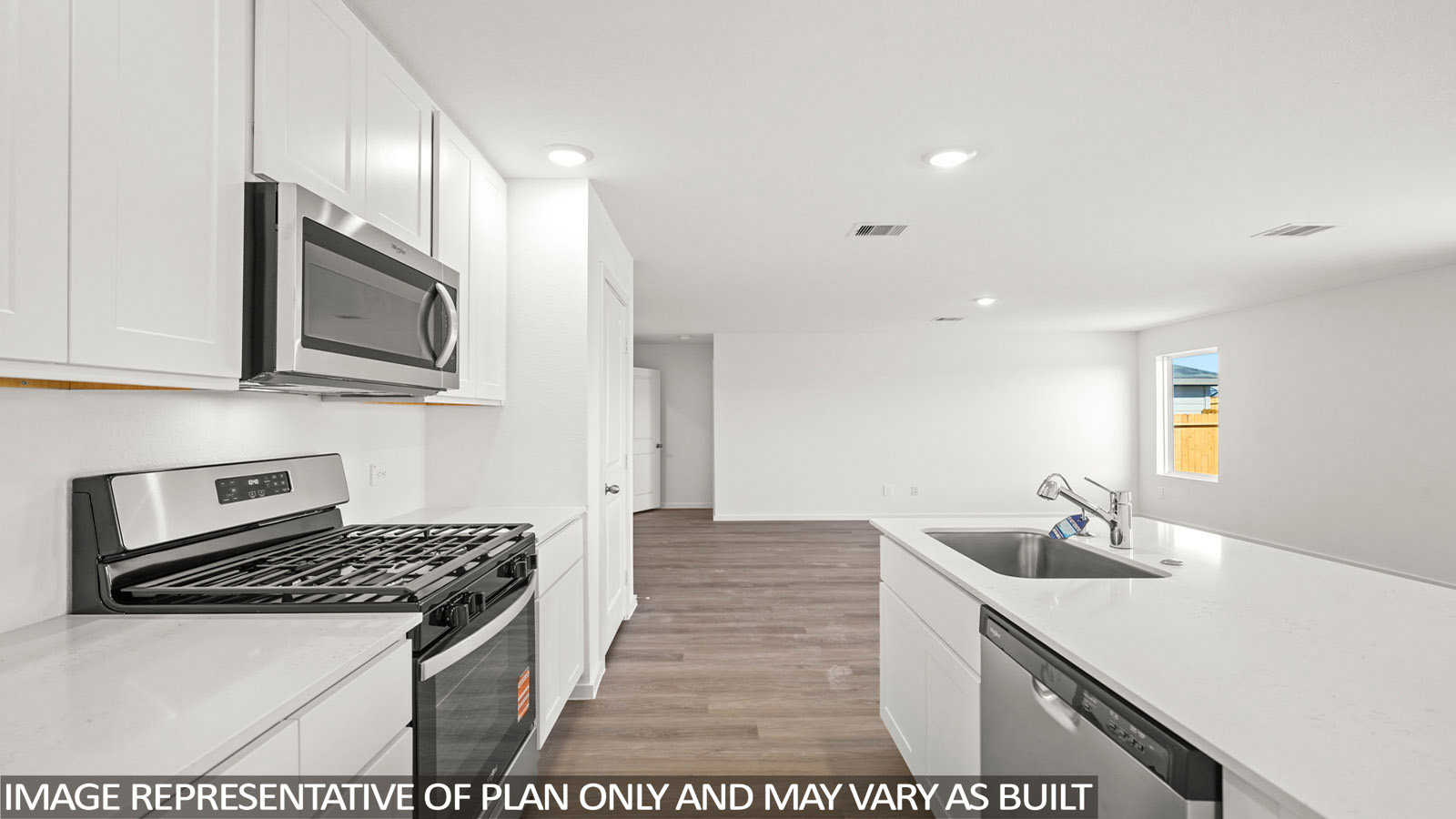 156 Baby Calf Roping Road Jarrell, TX 76537 - Photo 4 of 22 A contemporary kitchen features bright white cabinetry and sleek stainless steel appliances, perfect for modern living.