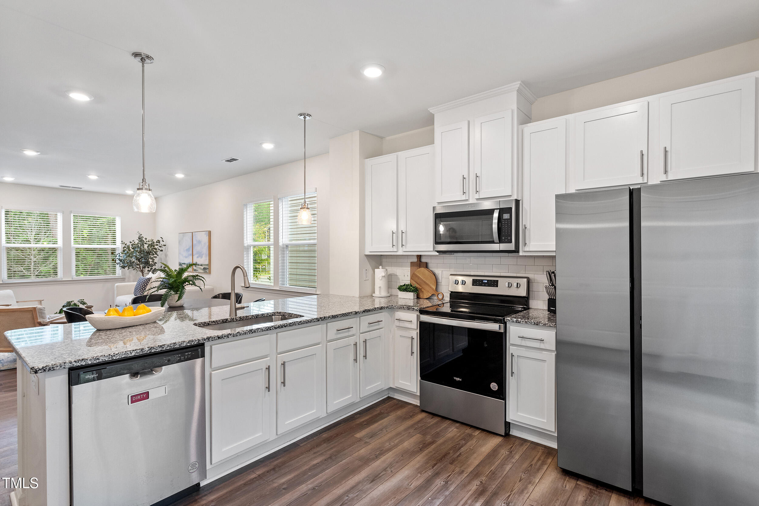 441 Hacksaw Trail Raleigh, NC 27610 - Photo 15 of 29 a kitchen with a sink stainless steel appliances and white cabinets