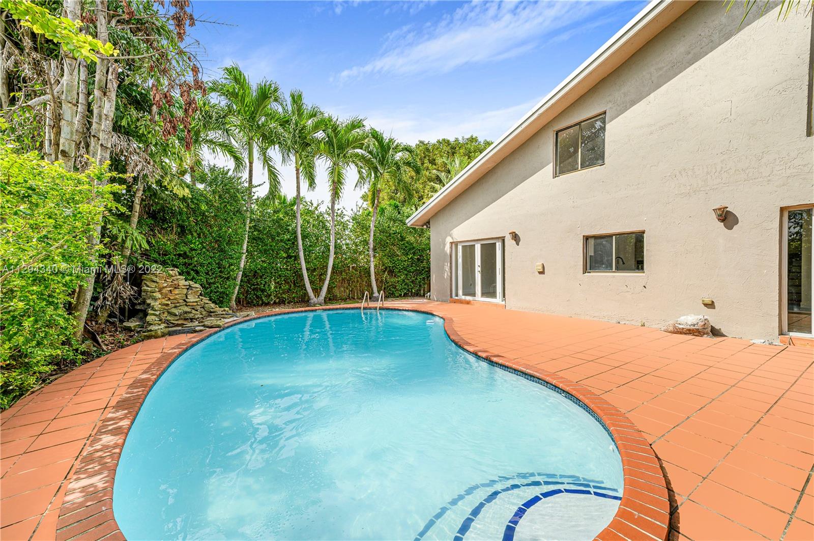 a view of a swimming pool with a patio