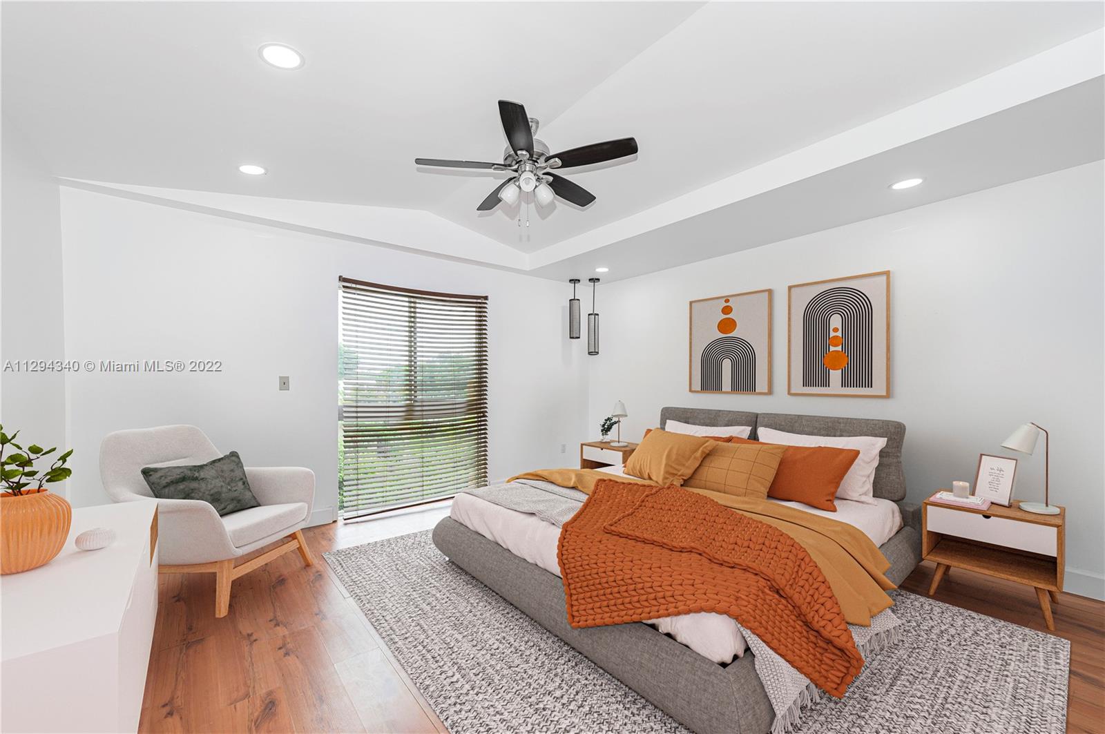14442 Southwest 111th Street Miami, FL 33186 - Photo 12 of 15 a bedroom with a large bed and a chandelier