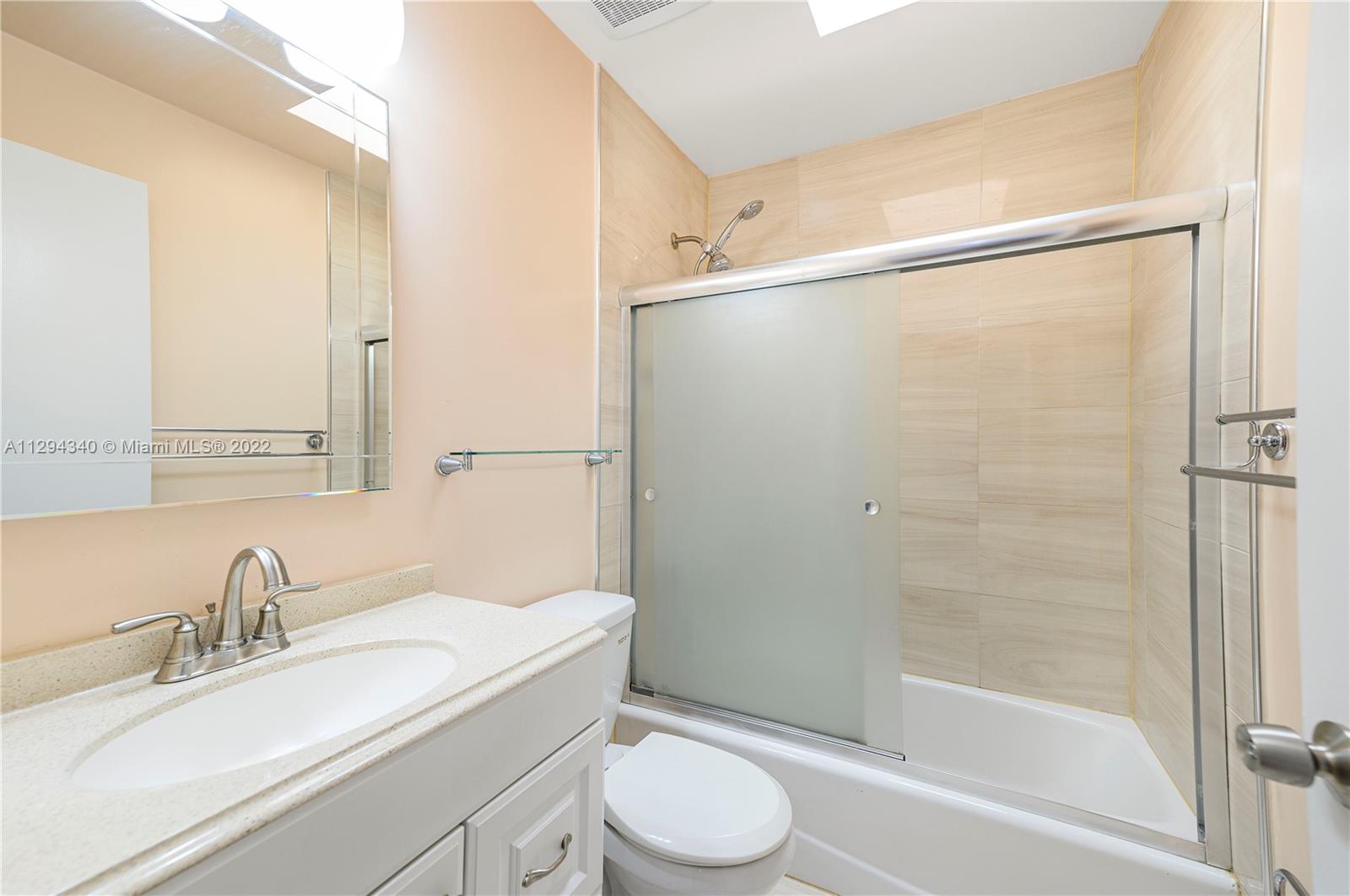 14442 Southwest 111th Street Miami, FL 33186 - Photo 14 of 15 a bathroom with a sink toilet and shower