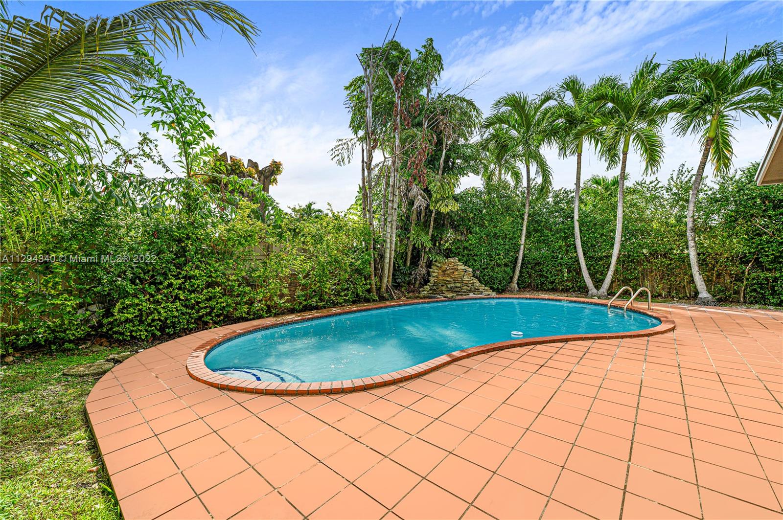 14442 Southwest 111th Street Miami, FL 33186 - Photo 15 of 15 a view of a swimming pool with a yard