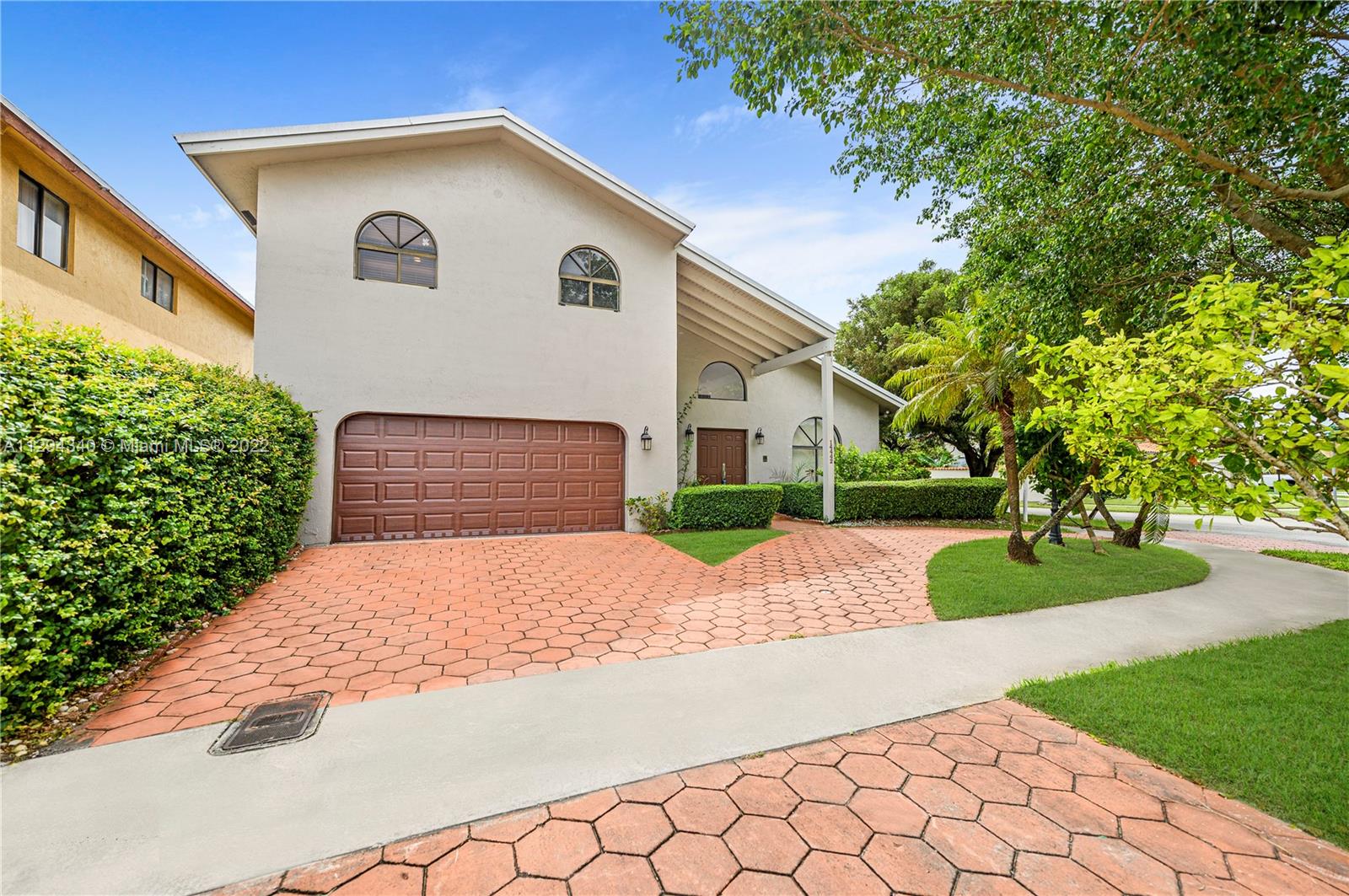 14442 Southwest 111th Street Miami, FL 33186 - Photo 2 of 15 a front view of a house with a yard and a garage