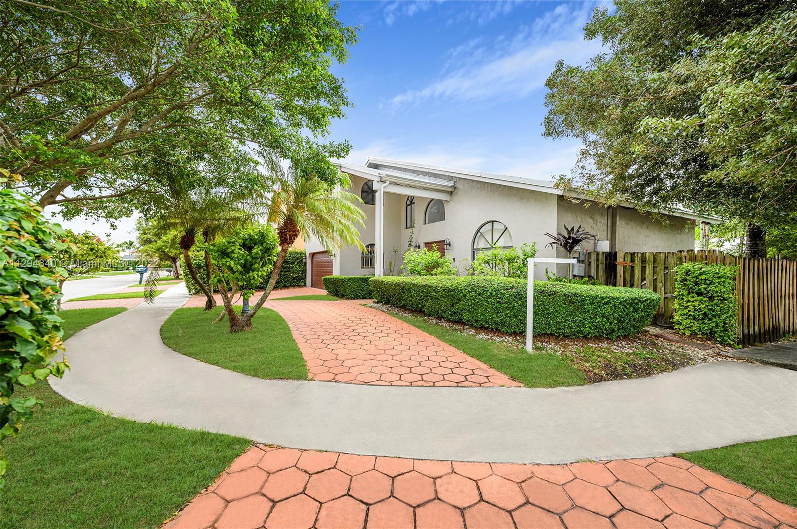 14442 Southwest 111th Street Miami, FL 33186 - Photo 4 of 15 a front view of a house with garden
